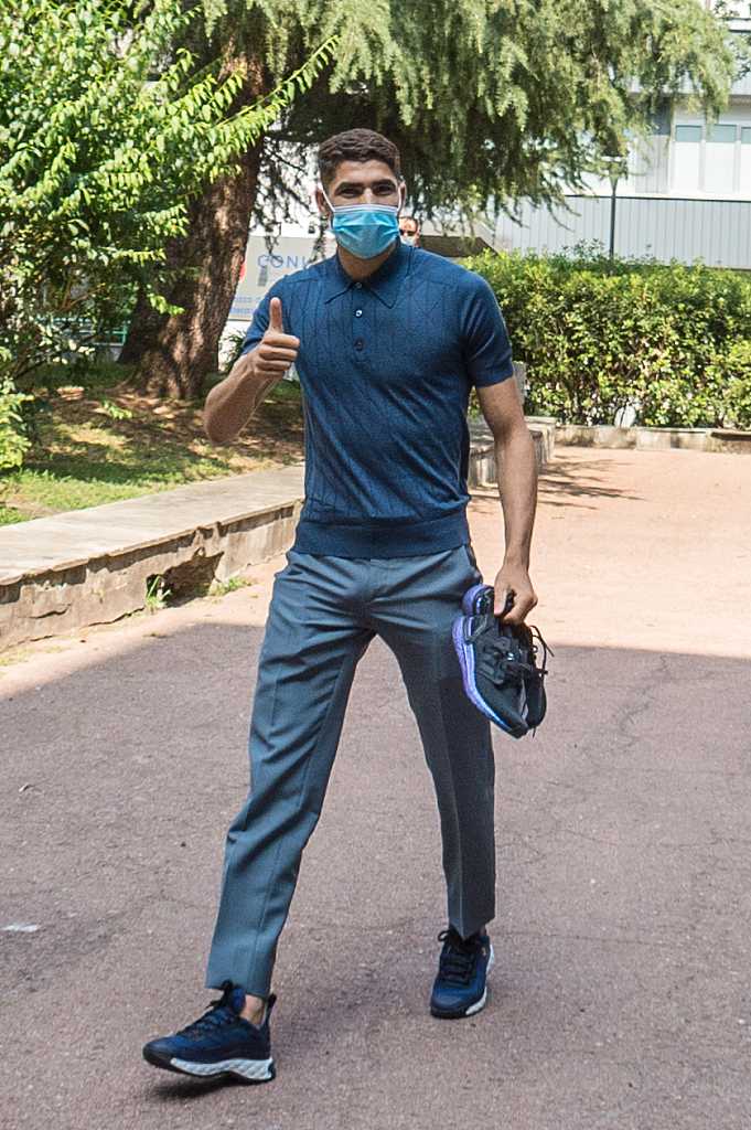 镜头拉近，阿什拉夫在室内接受例行检查时神情专注。他身穿简约的白色T恤，外搭一件深色外套，目光平和地望向前方。这一刻，他正经历着加盟国际米兰前最后的关键程序——体检。从多特蒙德到米兰城，这条路上凝聚了他无数汗水，而此刻的平静之下，蕴藏的是即将征服新战场的磅礴力量。
