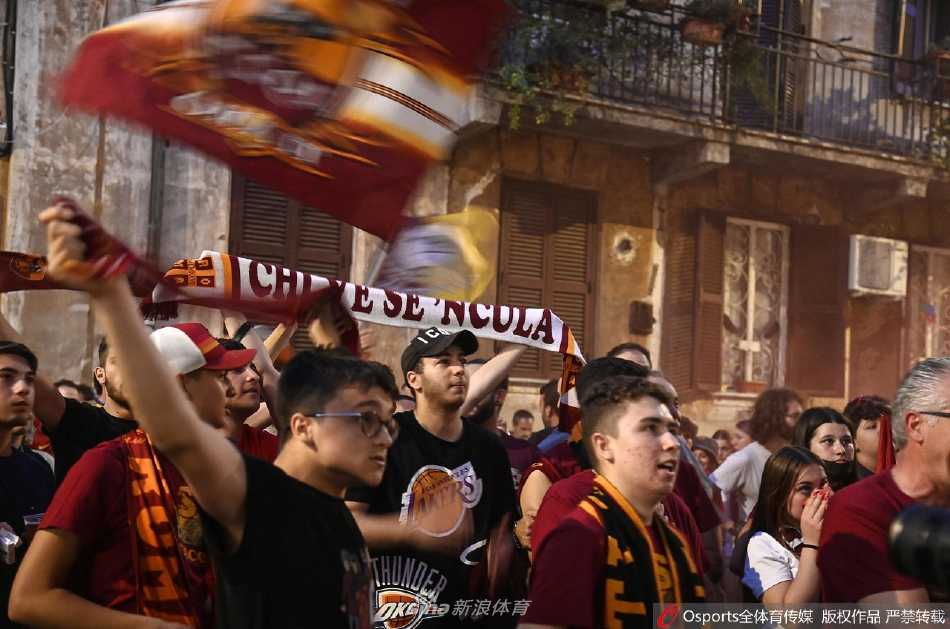 罗马奥林匹克球场外，球迷高举围巾与旗帜，红色烟雾弥漫夜空，庆祝球队载誉归来