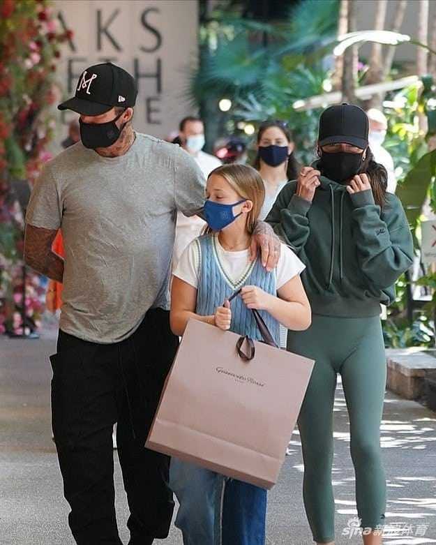 阳光洒在迈阿密的街道上，小七哈珀身穿休闲叠搭装束，步伐自信地跟在父亲贝克汉姆身旁，她微微侧头，神情专注而放松，已显露出超越年龄的沉稳气质。